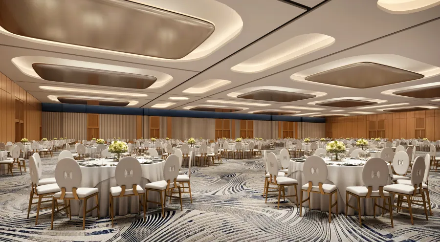 Modern Las Vegas ballroom venue at Fontainebleau designed for corporate galas and luxury events with white chairs, round tables, and contemporary lighting.