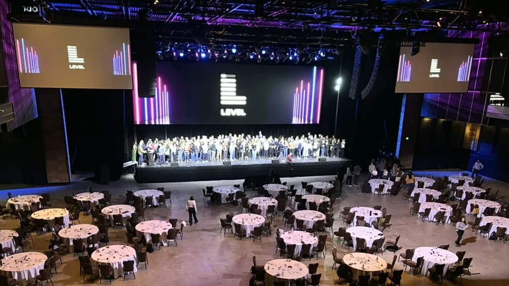 Las Vegas corporate offsite event venue with stage and dinner setup